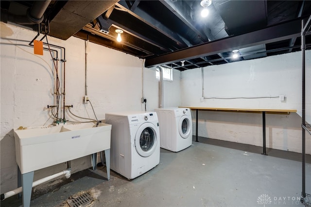 washroom with separate washer and dryer and laundry area