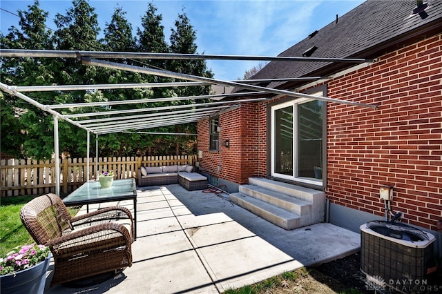 view of patio featuring entry steps, fence, central AC, and outdoor lounge area