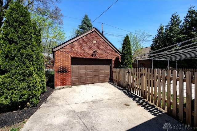 detached garage featuring fence