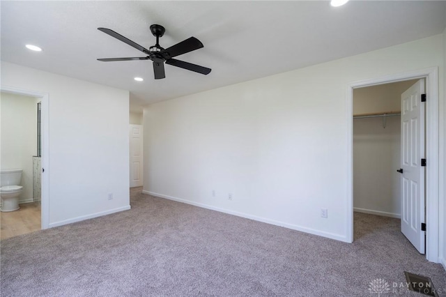 6450 E Welcome Rd, Hillsboro, OH 45133 - unfurnished bedroom featuring a walk in closet, baseboards, carpet, and recessed lighting