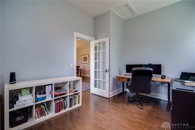 office space featuring french doors, attic access, baseboards, and wood finished floors