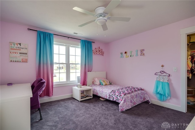 bedroom with ceiling fan, carpet, baseboards, a spacious closet, and visible vents