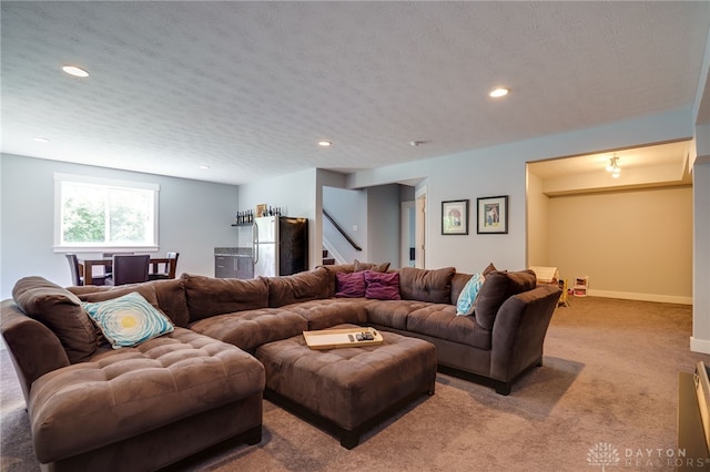 carpeted living area with recessed lighting, a textured ceiling, stairs, and baseboards
