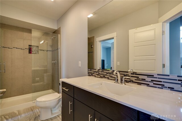 full bath featuring backsplash, a stall shower, and toilet