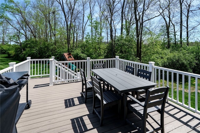 wooden deck featuring outdoor dining area and a playground