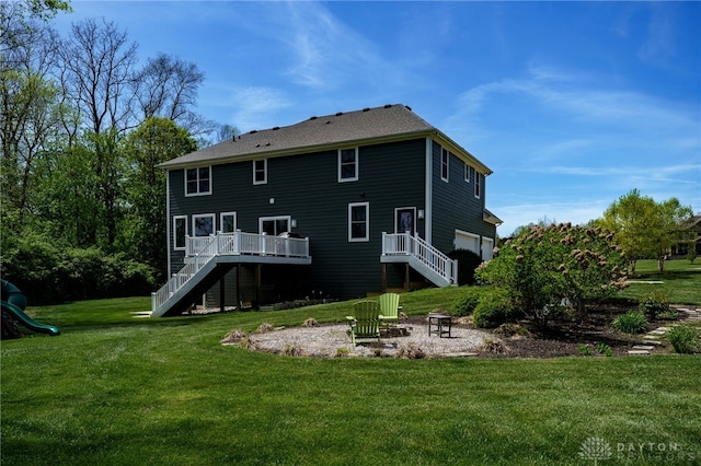 back of house with stairs, a lawn, and a deck
