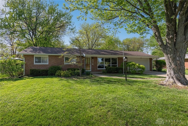 ranch-style house with brick siding, driveway, a front yard, and a garage