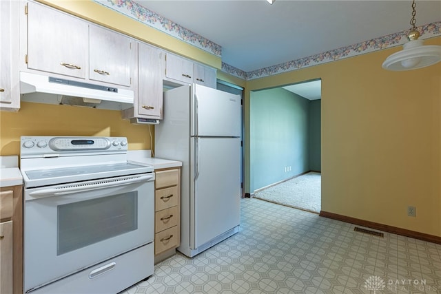 kitchen featuring baseboards, light countertops, under cabinet range hood, and white appliances