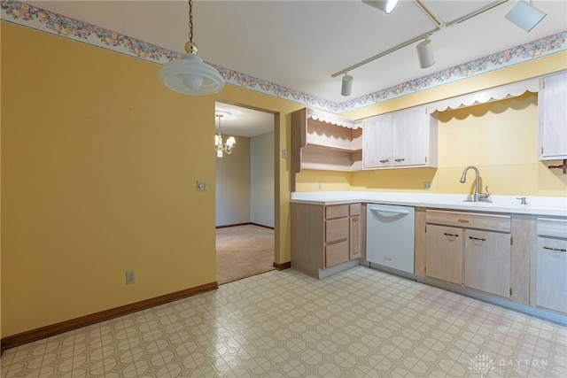 kitchen featuring baseboards, light countertops, a sink, and dishwasher