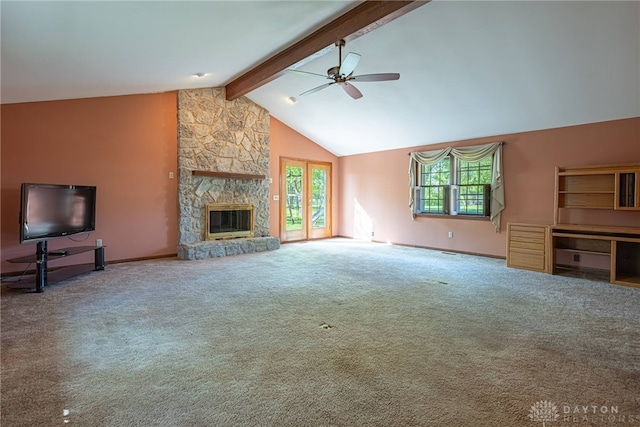 unfurnished living room with a ceiling fan, a fireplace, carpet floors, baseboards, and vaulted ceiling with beams