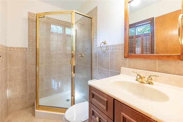 bathroom featuring vanity, tile walls, a shower stall, and toilet