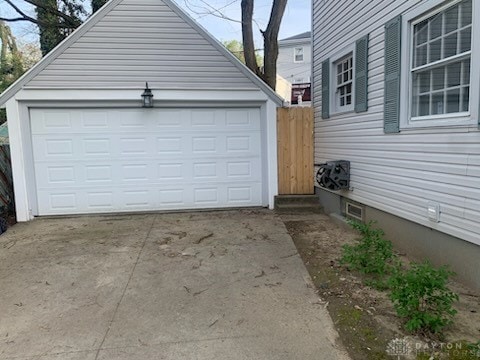 garage featuring concrete driveway