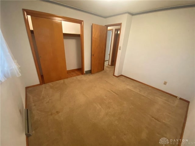 unfurnished bedroom with baseboards, carpet, and a closet