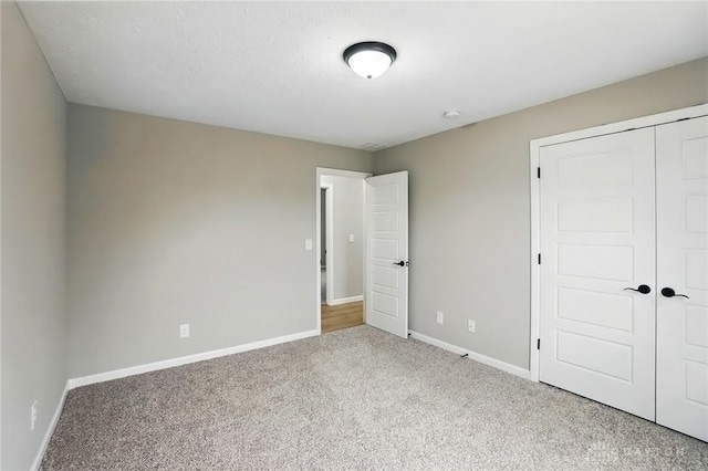 2067 Pine Forest Dr, Miamisburg, OH 45342 - unfurnished bedroom with carpet floors, baseboards, and a closet