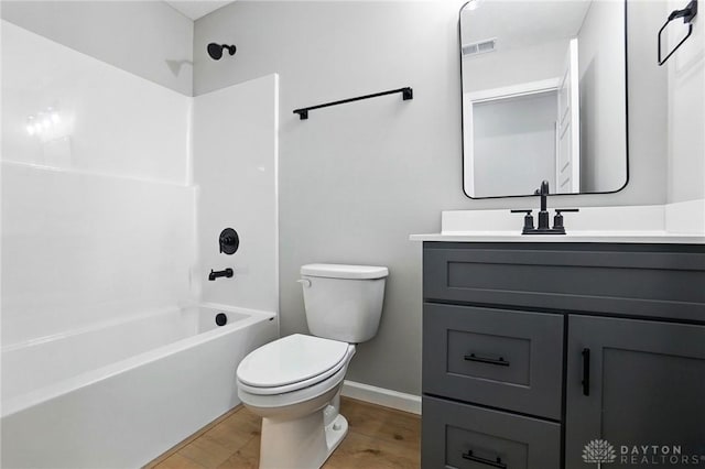 2067 Pine Forest Dr, Miamisburg, OH 45342 - full bathroom featuring vanity, toilet, shower / bath combination, wood finished floors, and baseboards