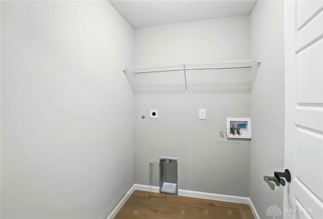 2067 Pine Forest Dr, Miamisburg, OH 45342 - washroom featuring hookup for an electric dryer, washer hookup, wood finished floors, baseboards, and heating unit