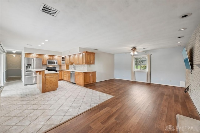 871 Van Eaton Rd, Spring Valley Twp, OH 45385 - kitchen with a ceiling fan, visible vents, light countertops, open floor plan, and stainless steel appliances
