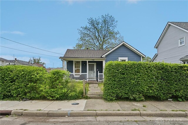 1566 Cora St, Springfield, OH 45503 - view of front of property featuring covered porch, a gate, a fenced front yard, and roof with shingles