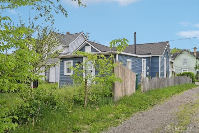 1566 Cora St, Springfield, OH 45503 - view of property exterior with dirt driveway and a shingled roof