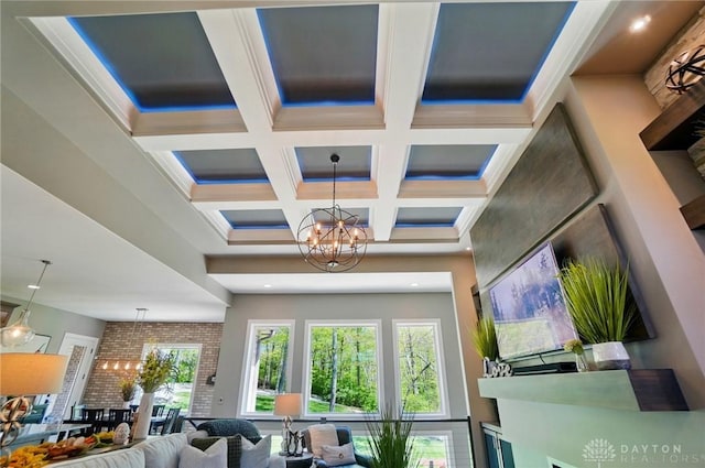interior space with a high ceiling, beamed ceiling, coffered ceiling, and a chandelier
