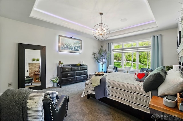 carpeted bedroom featuring a raised ceiling and a notable chandelier
