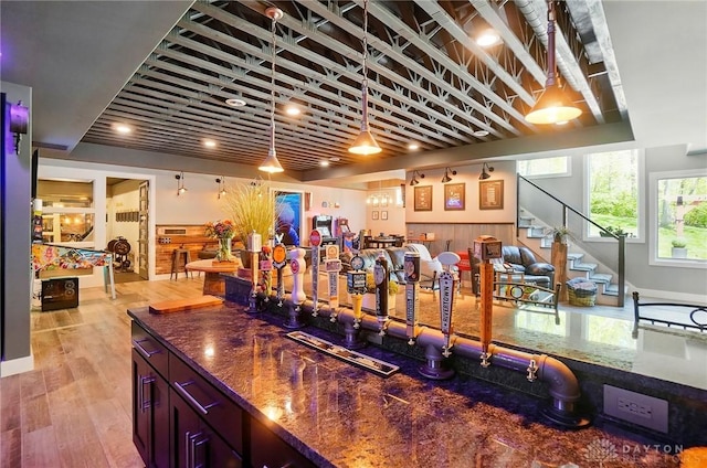 bar featuring light wood-style flooring and stairway
