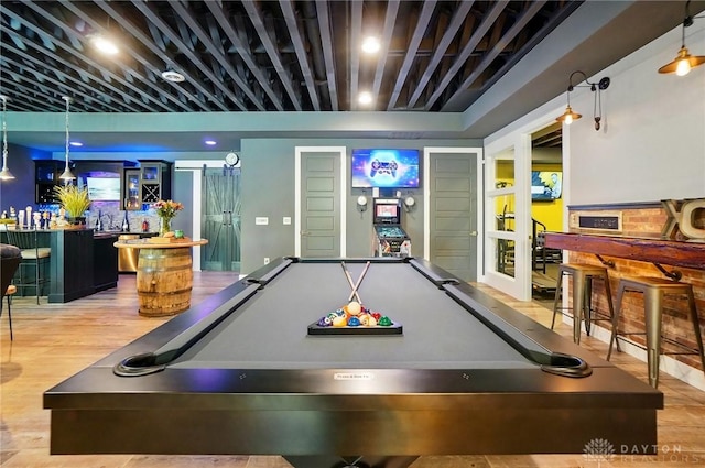 game room featuring pool table, bar area, french doors, and wood finished floors