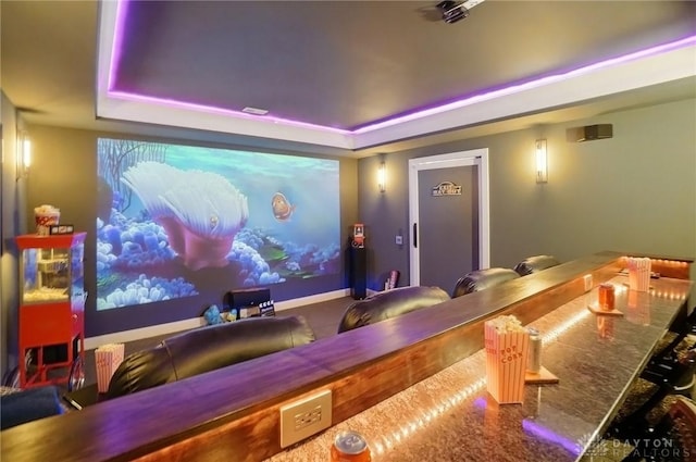 carpeted cinema with a tray ceiling