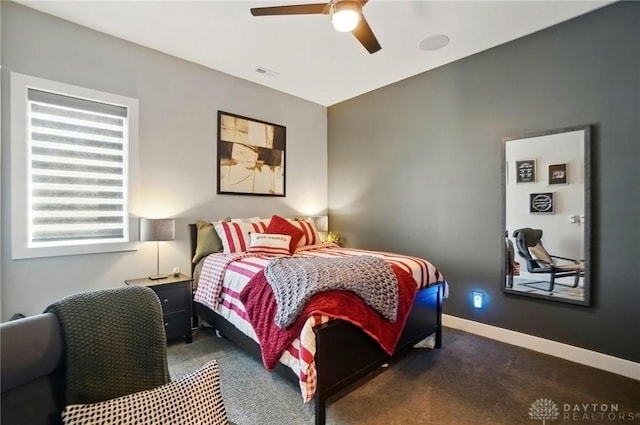 carpeted bedroom with visible vents, a ceiling fan, and baseboards