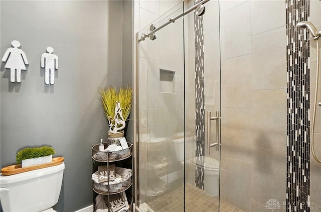 full bathroom featuring a shower stall and toilet