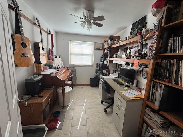 office with light tile patterned floors and ceiling fan