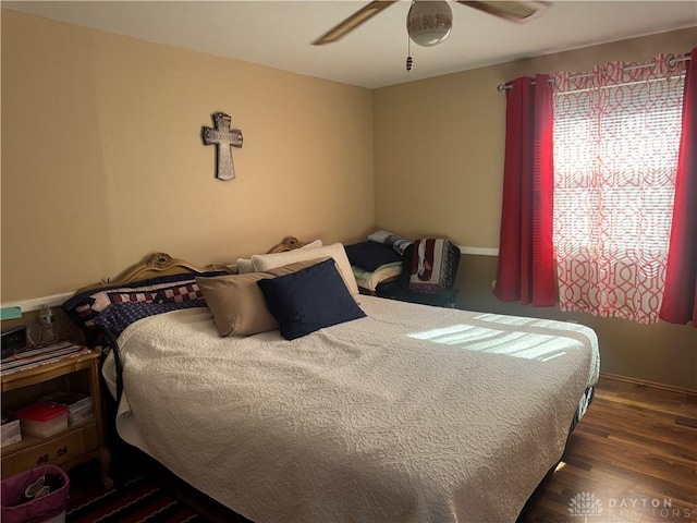 bedroom with a ceiling fan and wood finished floors