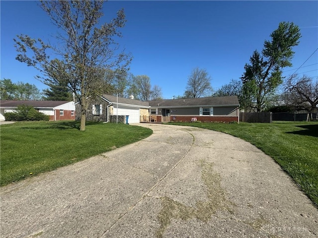 single story home featuring fence, an attached garage, driveway, and a front lawn