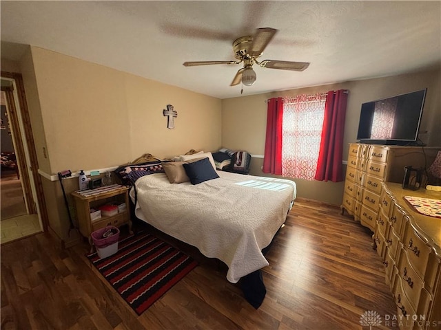 bedroom with a ceiling fan and wood finished floors