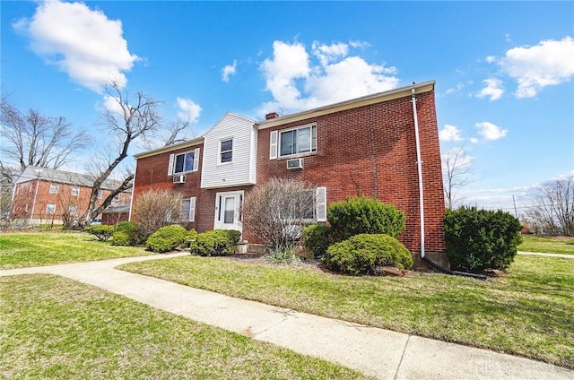 2334 Davue Cir, Dayton, OH 45406 - view of front of house featuring brick siding, an AC wall unit, and a front yard