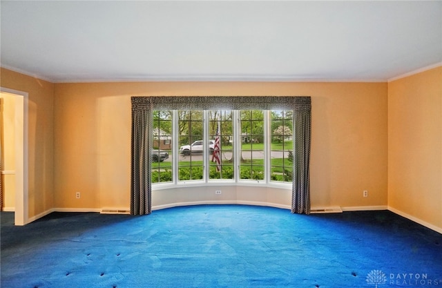 unfurnished room featuring baseboards, ornamental molding, carpet flooring, and visible vents