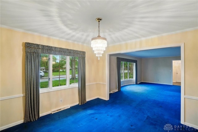 unfurnished room with visible vents, baseboards, a notable chandelier, ornamental molding, and carpet flooring