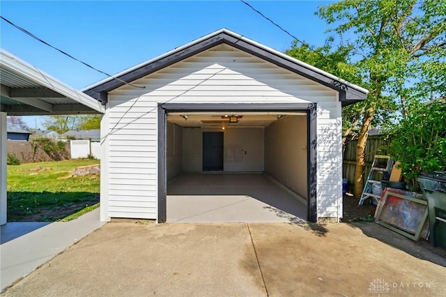 detached garage featuring fence