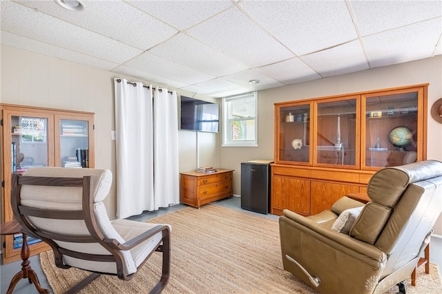 sitting room with a paneled ceiling