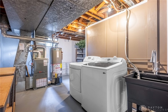 laundry room featuring water heater, laundry area, and independent washer and dryer