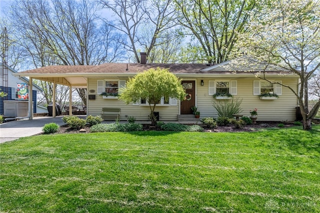 single story home featuring entry steps, driveway, a carport, and a front lawn