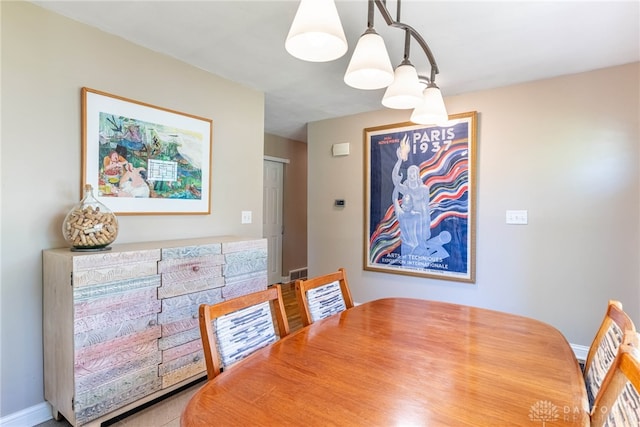 dining room featuring baseboards and visible vents