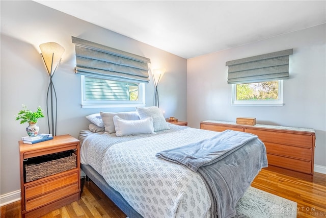 bedroom with baseboards and wood finished floors