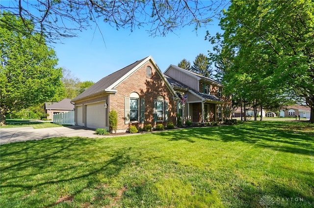 view of front facade with a garage, driveway, a front lawn, and brick siding