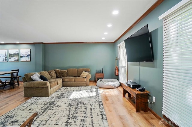 living area with crown molding, recessed lighting, baseboards, and wood finished floors