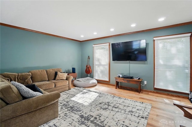 living room with recessed lighting, ornamental molding, baseboards, and wood finished floors