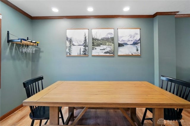 dining area with light wood-style floors, ornamental molding, and recessed lighting