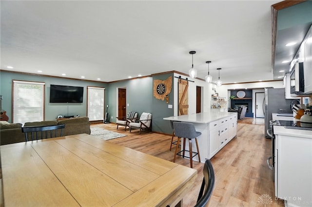 dining area with recessed lighting, baseboards, and light wood-style flooring