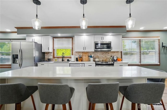kitchen featuring backsplash, appliances with stainless steel finishes, and light countertops