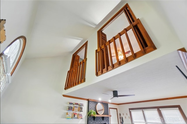 interior space featuring ornamental molding, a towering ceiling, ceiling fan, and a wealth of natural light